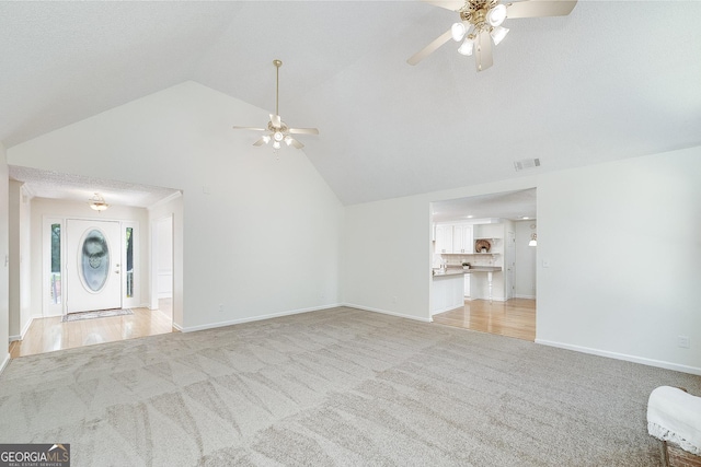 110 Chardonnay Oaks Dr, Mcdonough, GA 30252 - unfurnished living room featuring a ceiling fan, light colored carpet, and high vaulted ceiling