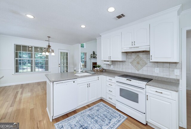 110 Chardonnay Oaks Dr, Mcdonough, GA 30252 - kitchen featuring white appliances, under cabinet range hood, a peninsula, white cabinets, and backsplash