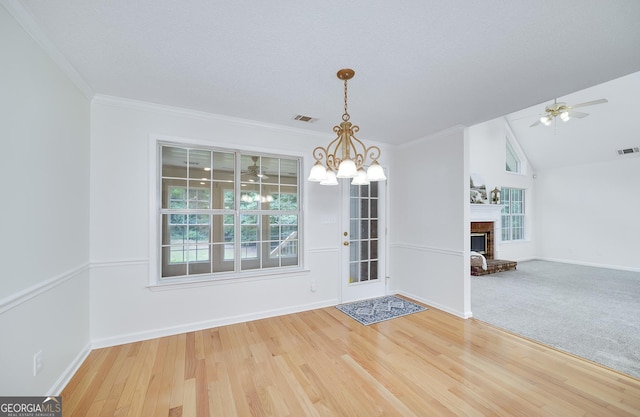110 Chardonnay Oaks Dr, Mcdonough, GA 30252 - unfurnished dining area with plenty of natural light, light wood-style flooring, ceiling fan, a fireplace, and crown molding
