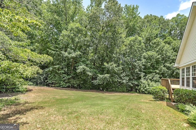 110 Chardonnay Oaks Dr, Mcdonough, GA 30252 - view of grassy yard featuring a wooden deck