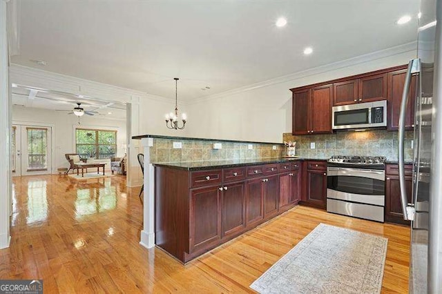 3202 Saute Way, Avondale Estates, GA 30002 - kitchen featuring stainless steel appliances, a peninsula, dark brown cabinets, light wood finished floors, and crown molding