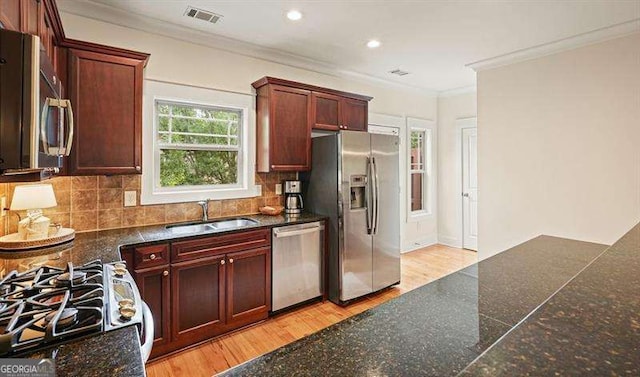 3202 Saute Way, Avondale Estates, GA 30002 - kitchen featuring appliances with stainless steel finishes, crown molding, decorative backsplash, light wood finished floors, and recessed lighting