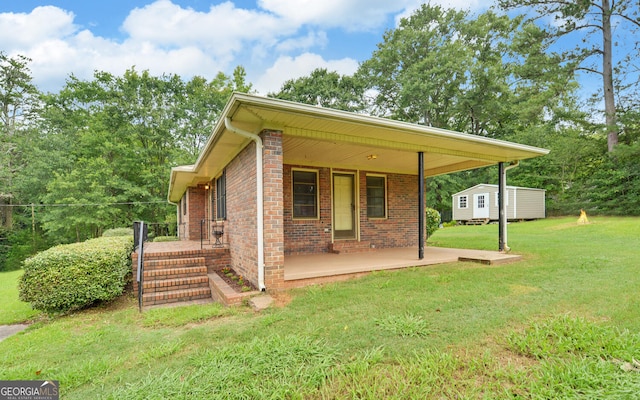 37 Cunningham Dr, Hartwell, GA 30643 - back of house featuring a lawn, brick siding, a storage shed, and a porch