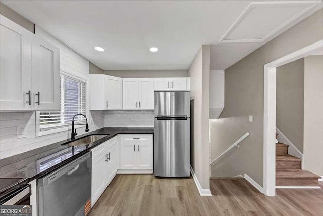 847 Magna Carta Dr NW, Atlanta, GA 30318 - kitchen with stainless steel appliances, white cabinets, light wood-style floors, and recessed lighting