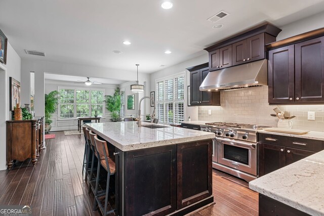 452 Rockford Pass, Marietta, GA 30064 - kitchen featuring extractor fan, high end stove, plenty of natural light, light stone counters, and recessed lighting