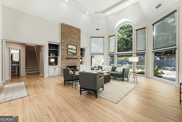 625 Wynfield Ct, Roswell, GA 30076 - living room with a towering ceiling, wood finished floors, built in features, a large fireplace, and stairway