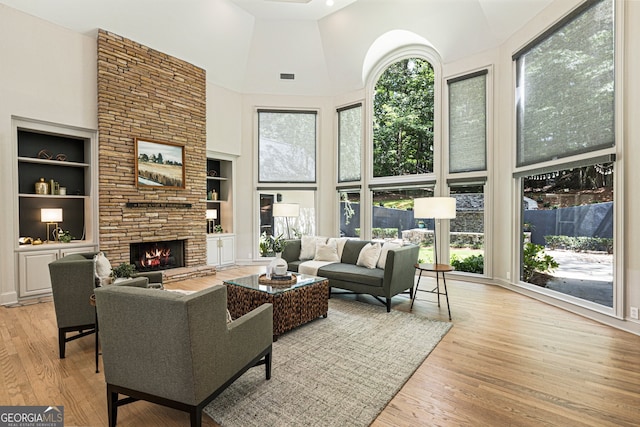 625 Wynfield Ct, Roswell, GA 30076 - living room with a towering ceiling, built in features, wood finished floors, and a fireplace