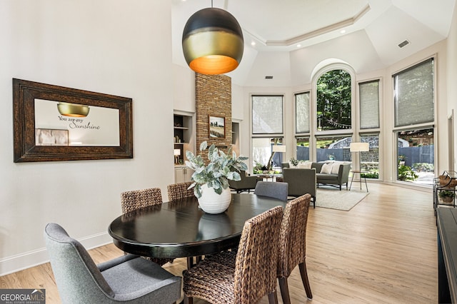 625 Wynfield Ct, Roswell, GA 30076 - dining room with a high ceiling, light wood finished floors, a tray ceiling, recessed lighting, and built in shelves