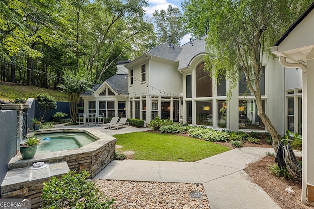 625 Wynfield Ct, Roswell, GA 30076 - back of property featuring an in-ground hot tub, a patio, roof with shingles, stucco siding, and a sunroom