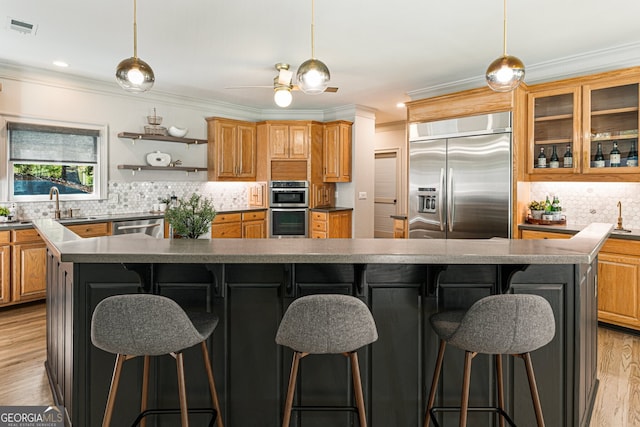 625 Wynfield Ct, Roswell, GA 30076 - kitchen with appliances with stainless steel finishes, ornamental molding, decorative backsplash, a breakfast bar, and a large island