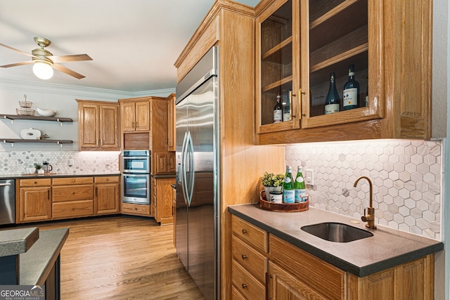 625 Wynfield Ct, Roswell, GA 30076 - kitchen featuring appliances with stainless steel finishes, tasteful backsplash, a ceiling fan, brown cabinets, and light wood finished floors