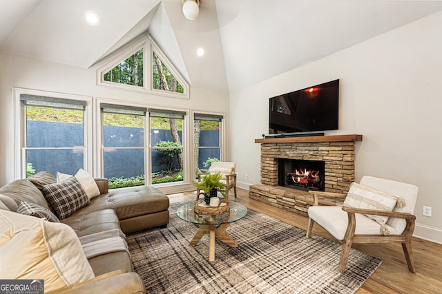 625 Wynfield Ct, Roswell, GA 30076 - living room featuring wood finished floors, a stone fireplace, high vaulted ceiling, healthy amount of natural light, and a ceiling fan