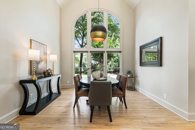 625 Wynfield Ct, Roswell, GA 30076 - dining space with high vaulted ceiling, healthy amount of natural light, and light wood-style flooring