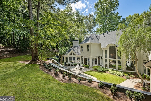 625 Wynfield Ct, Roswell, GA 30076 - back of property featuring a yard, roof with shingles, a patio, stucco siding, and a chimney