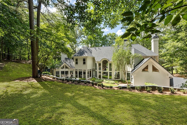 625 Wynfield Ct, Roswell, GA 30076 - rear view of property with a chimney, a shingled roof, a lawn, and stucco siding