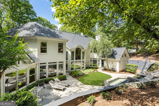 625 Wynfield Ct, Roswell, GA 30076 - rear view of house with a patio area, a shingled roof, stucco siding, and a sunroom