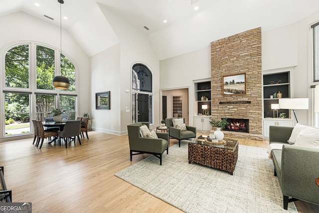 625 Wynfield Ct, Roswell, GA 30076 - living area featuring high vaulted ceiling, wood finished floors, built in features, a fireplace, and recessed lighting