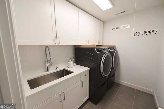 1895 Henley Way, Alpharetta, GA 30009 - washroom with washer and clothes dryer, cabinet space, and dark tile patterned floors