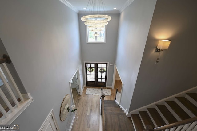 1895 Henley Way, Alpharetta, GA 30009 - foyer entrance featuring a chandelier, stairway, wood finished floors, ornamental molding, and french doors