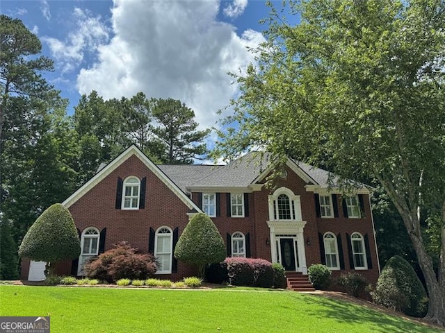 1464 Chatsworth Trce, Lawrenceville, GA 30044 - georgian-style home with a front yard and brick siding