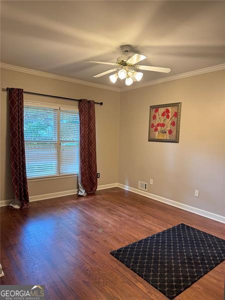 1464 Chatsworth Trce, Lawrenceville, GA 30044 - unfurnished room with a ceiling fan, wood finished floors, and crown molding