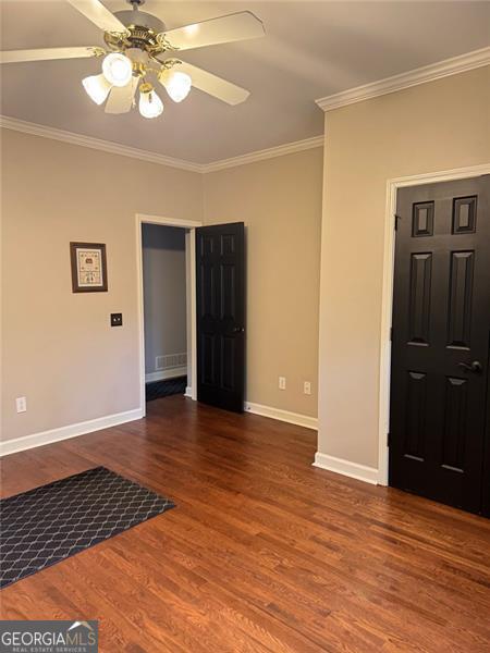 1464 Chatsworth Trce, Lawrenceville, GA 30044 - empty room featuring crown molding, wood finished floors, and a ceiling fan