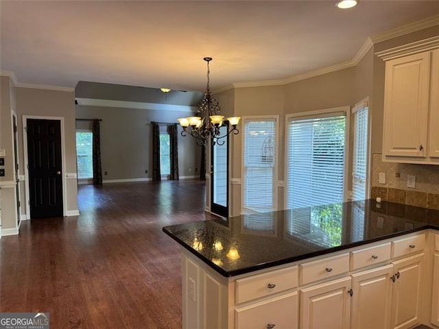1464 Chatsworth Trce, Lawrenceville, GA 30044 - kitchen featuring a chandelier, open floor plan, a peninsula, dark wood-type flooring, and decorative backsplash