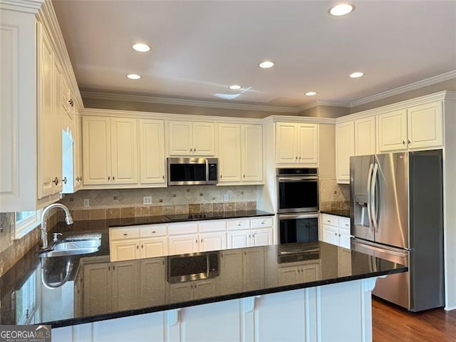 1464 Chatsworth Trce, Lawrenceville, GA 30044 - kitchen with stainless steel appliances, crown molding, a peninsula, recessed lighting, and white cabinets