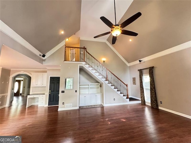 1464 Chatsworth Trce, Lawrenceville, GA 30044 - unfurnished living room featuring stairs, high vaulted ceiling, ceiling fan, wood finished floors, and arched walkways
