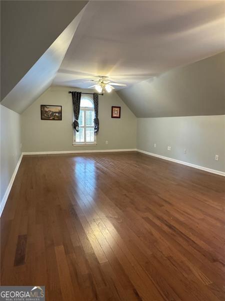 1464 Chatsworth Trce, Lawrenceville, GA 30044 - additional living space featuring dark wood finished floors, vaulted ceiling, and ceiling fan