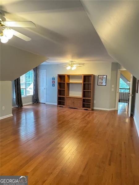 1464 Chatsworth Trce, Lawrenceville, GA 30044 - unfurnished living room with a ceiling fan, wood finished floors, and lofted ceiling