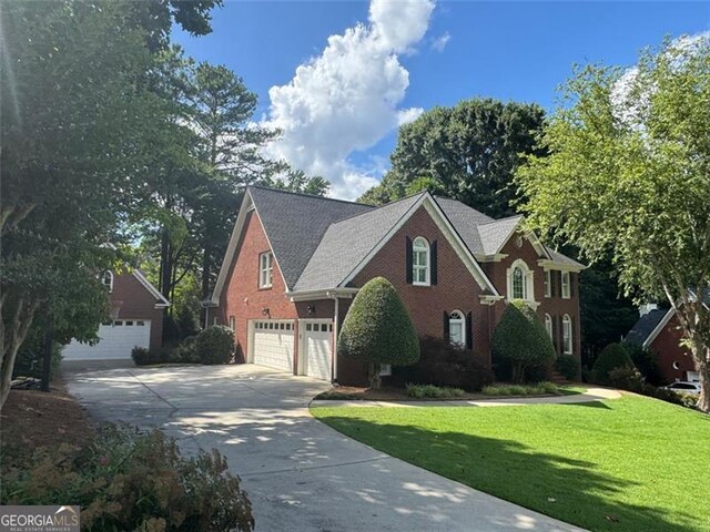 1464 Chatsworth Trce, Lawrenceville, GA 30044 - view of front of home featuring driveway, a front yard, and brick siding