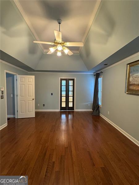 1464 Chatsworth Trce, Lawrenceville, GA 30044 - unfurnished living room with lofted ceiling, ceiling fan, dark wood-style floors, french doors, and crown molding