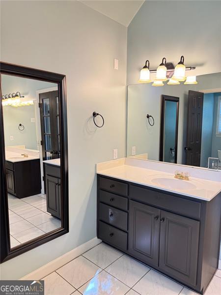 1464 Chatsworth Trce, Lawrenceville, GA 30044 - bathroom featuring lofted ceiling and vanity