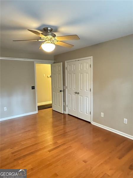 1464 Chatsworth Trce, Lawrenceville, GA 30044 - unfurnished bedroom featuring wood finished floors, a closet, and ceiling fan