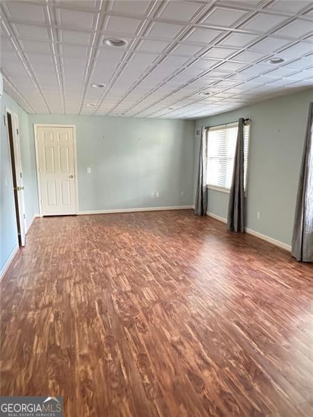 1464 Chatsworth Trce, Lawrenceville, GA 30044 - spare room featuring wood finished floors and baseboards