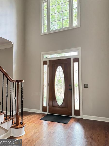 1464 Chatsworth Trce, Lawrenceville, GA 30044 - foyer with a towering ceiling, wood finished floors, and stairs