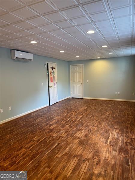 1464 Chatsworth Trce, Lawrenceville, GA 30044 - spare room featuring a wall mounted air conditioner, wood finished floors, and recessed lighting