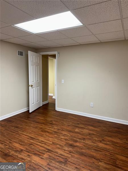 1464 Chatsworth Trce, Lawrenceville, GA 30044 - spare room featuring dark wood-type flooring and a paneled ceiling