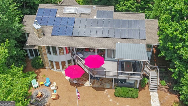 212 Windjammer Dr, Hiawassee, GA 30546 - view of front of home featuring a shingled roof, stairs, solar panels, and a fire pit