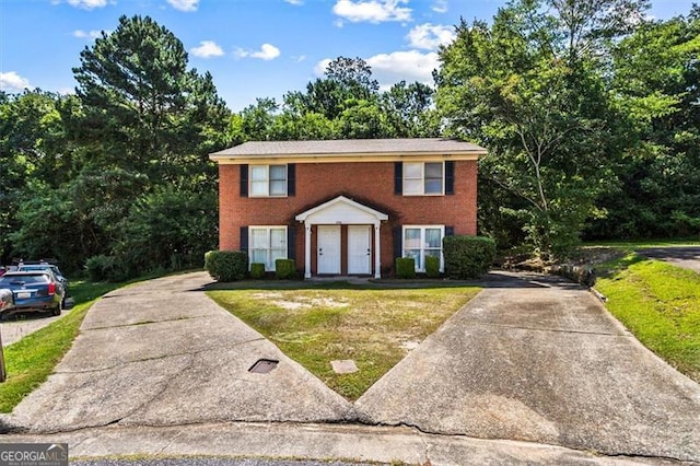 4146 Monclair, Columbus, GA 31907 - colonial house with concrete driveway, a front lawn, and brick siding