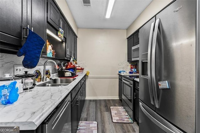 4146 Monclair, Columbus, GA 31907 - kitchen with stainless steel appliances, dark wood-type flooring, dark cabinetry, and tasteful backsplash