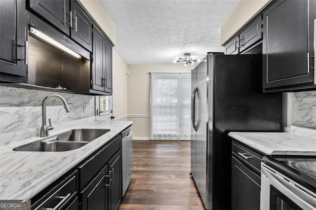 4146 Monclair, Columbus, GA 31907 - kitchen with backsplash, dark cabinetry, appliances with stainless steel finishes, a textured ceiling, and dark wood-style flooring