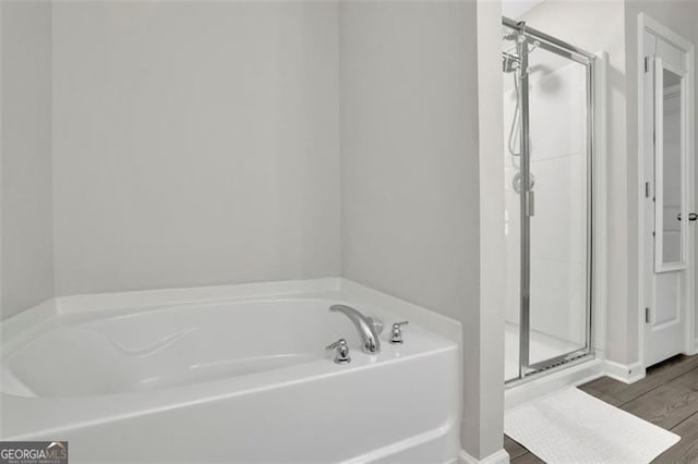 1969 Lanier Harbor Pt, Buford, GA 30518 - full bathroom featuring a bath, a stall shower, and wood finished floors