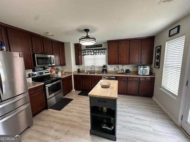 298 Timberwind Dr, Byron, GA 31008 - kitchen with appliances with stainless steel finishes, plenty of natural light, open shelves, and light wood-type flooring