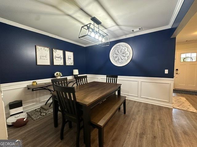 298 Timberwind Dr, Byron, GA 31008 - dining room featuring wainscoting, wood finished floors, a decorative wall, and ornamental molding