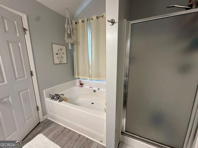 298 Timberwind Dr, Byron, GA 31008 - full bathroom with a shower stall, a bath, wood finished floors, and lofted ceiling