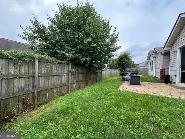 298 Timberwind Dr, Byron, GA 31008 - fenced backyard with a patio area