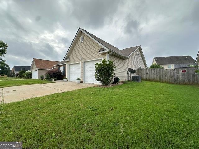 298 Timberwind Dr, Byron, GA 31008 - view of property exterior featuring concrete driveway and an attached garage