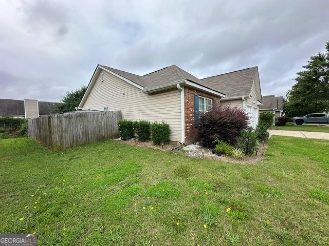 298 Timberwind Dr, Byron, GA 31008 - view of property exterior with brick siding, an attached garage, and concrete driveway